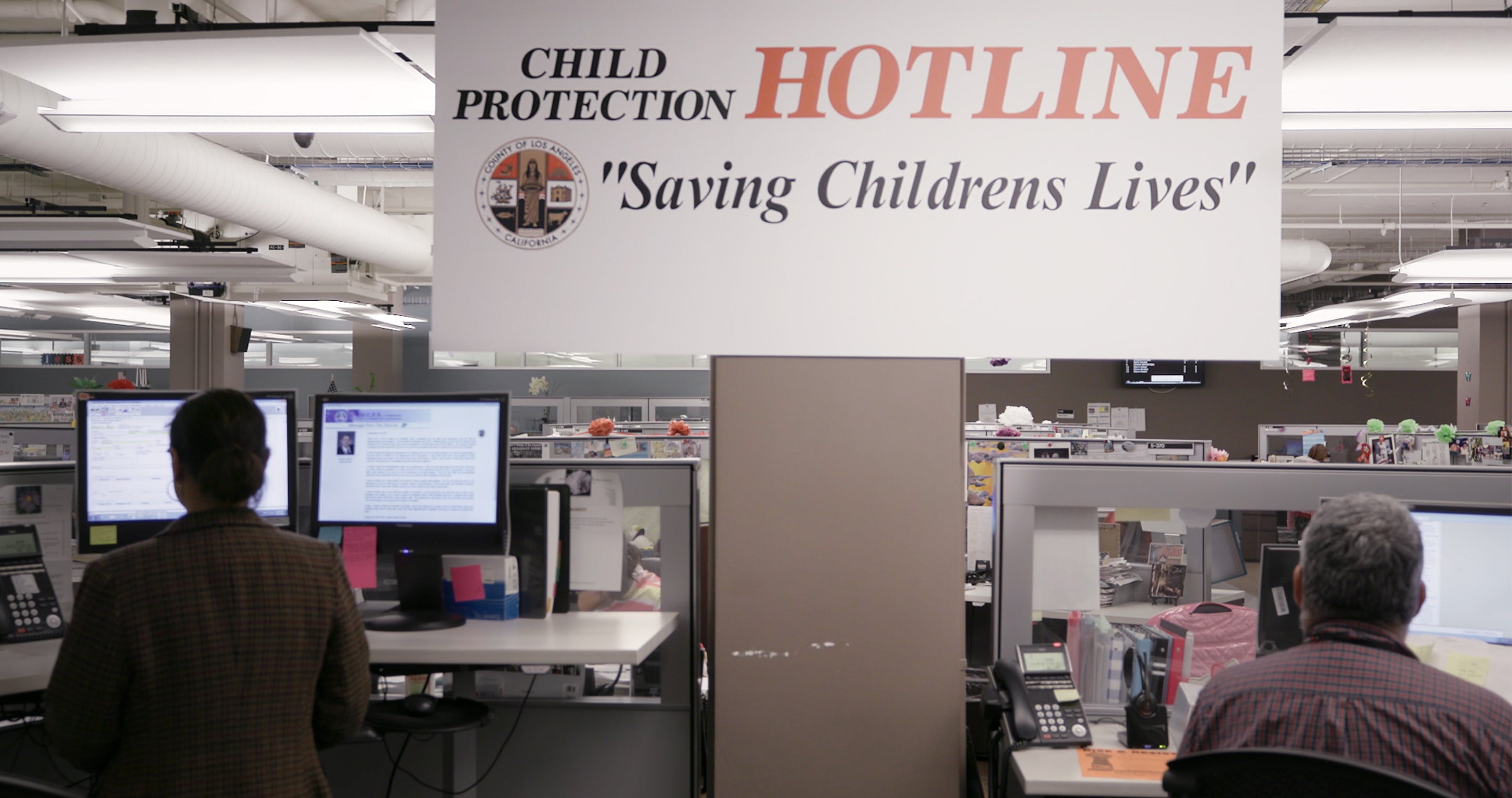 5f1bc22e673cf68b819ffe8e3c3a12f2d603aca6_foster_still_015_children-protection-hotline-sign